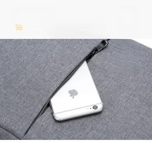 Detail of grey laptop bag featuring a textured fabric and hidden zipper pocket for smartphone