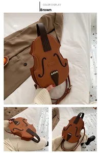 Detailed view of violin-shaped crossbody bag in brown faux leather with gold rivets