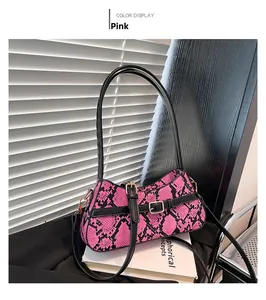 Detailed macro view of pink and black snakeskin pattern on a trendy shoulder bag