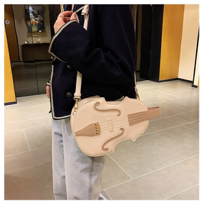 Macro shot of cream violin-shaped crossbody bag featuring intricate headstock and string details