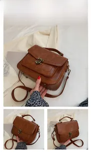 Detail view of vintage brown PU leather handbag with bronze lock and pebbled texture