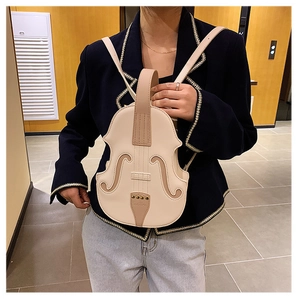 Detail of creative violin-shaped cream PU leather backpack featuring artistic stitching