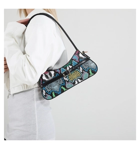 Detailed shot of colorful snakeskin pattern baguette bag with stylish chain and metal buckle