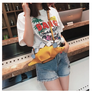 Close-up of yellow dinosaur shaped crossbody bag with colorful plates and brown strap