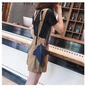 Detailed view of blue shark-shaped crossbody bag with 3D fins and matte PU leather texture