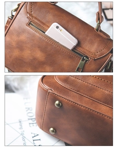 Detail view of the rear zipper pocket and golden protective base studs on the brown PU handbag