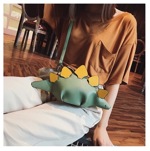 Detail shot of a creative dinosaur crossbody bag in green and yellow PU leather