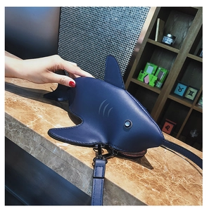 Detail shot of navy blue shark bag showing PU leather texture and fin design features