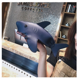 Detailed shot of a blue shark-shaped PU leather bag with zipper mouth and 3D fins