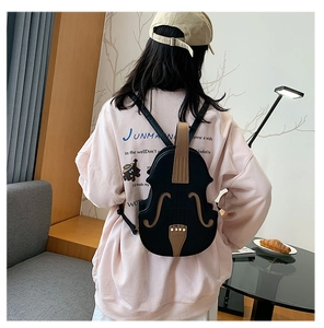 Detail of creative violin-shaped backpack in black and brown PU leather worn by model
