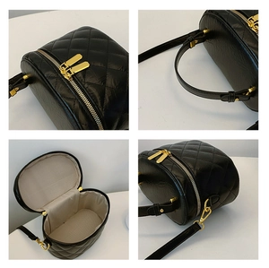 Detail of black quilted bucket bag featuring glossy PU leather and gold zipper