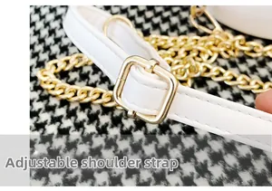 Detail of adjustable white leather strap with gold buckle and chain for round bag