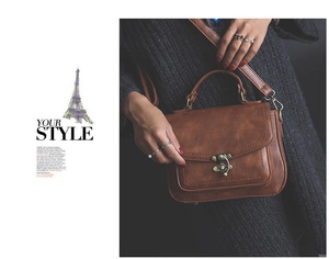 Detail of vintage caramel brown PU leather handbag featuring a bronze twist lock and top handle