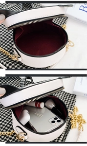 Internal view of a cute round panda bag showing capacity for phone and cosmetics