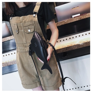 Detailed view of the creative shark-shaped crossbody bag worn on a casual outfit