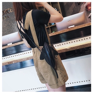 Detailed view of the creative shark-shaped crossbody bag in black faux leather finish