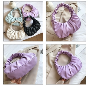 Detail view of ruched crescent underarm bags in purple, mint, beige, and black colors