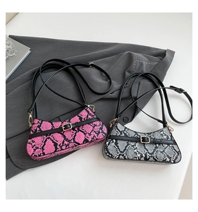 Detail of colorful snakeskin textured baguette bags with gold hardware and slim straps