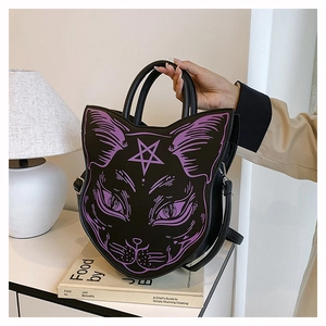 Detail of a black cat-shaped handbag with purple gothic prints and dual handles