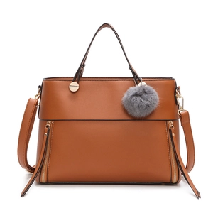 Brown vintage faux leather tote bag with dual handles and grey fur ball accessory
