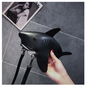 Detailed shot of creative shark-shaped crossbody bag with metal zipper and PU leather texture