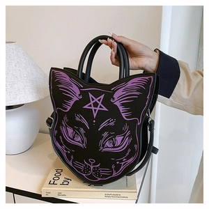 Detail of gothic black cat face handbag featuring purple star patterns and sturdy handles