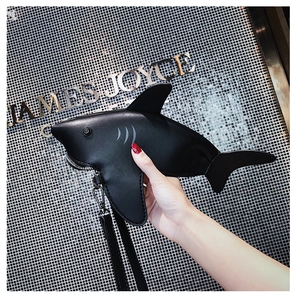 Detail view of the black shark shaped bag showing the faux leather texture and zipper