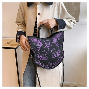 Detailed shot of dark gothic cat face handbag with purple print and adjustable strap
