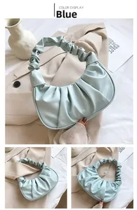 Detail view of light blue pleated dumpling bag with elegant gathered handle and PU leather