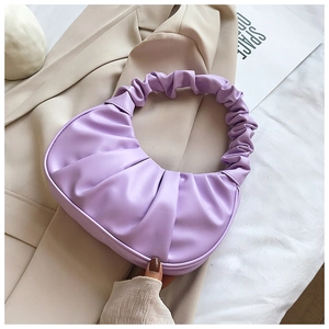 Detail of lavender pleated dumpling bag showing smooth PU leather texture and ruched handle
