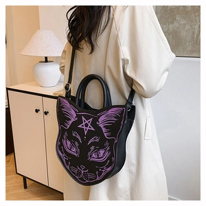 Back view of a gothic black cat crossbody bag with purple prints worn by a model
