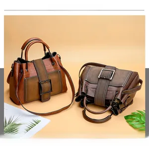 Detail of vintage matte brown multi-purpose bag with metallic buckle and shoulder straps
