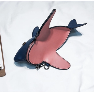 Detail view of mini shark bag with blue PU exterior and vibrant pink lining contrast