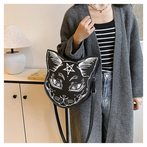 Close-up of gothic black cat crossbody bag with star pattern on a minimalist backdrop