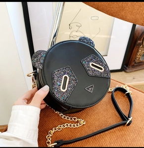 Detail of cute panda round bag with sequin accents and golden metal chain strap