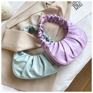 Detailed view of lavender and light green pleated cloud bags with soft ruffled straps
