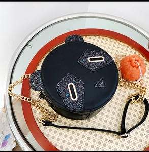 Close-up of cute panda crossbody bag featuring colorful sequins and gold chain strap