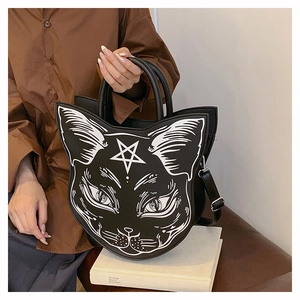 Detail of gothic black cat handbag with white star face print on a minimalist prop