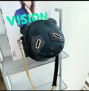 Detailed view of cute panda crossbody bag featuring sparkling sequins and gold chain strap