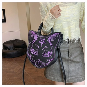 Detail of a black punk cat-shaped handbag with purple printed whiskers and pentagram