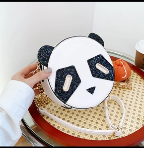 Close-up of cute panda shaped round bag with sparkling sequins and gold chain strap