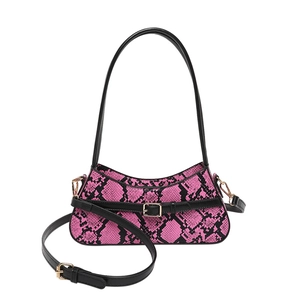 Pink and black snakeskin baguette shoulder bag with adjustable strap and gold buckle detail