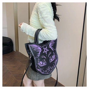 Detailed side view of cat-shaped crossbody bag with purple graphic and star detail