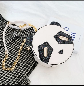 Detail of panda shaped round crossbody bag with black sequins and gold chain strap