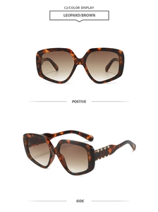 Dettaglio di occhiali da sole oversize leopardati con lenti sfumate marroni e accenti oro