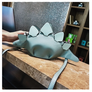Detail view of the mint green dinosaur shaped PU leather shoulder bag with back plates