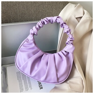 Detail of light purple ruched hobo bag with trendy pleated design on a fashion background