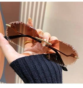 Detail of rimless sunglasses with serrated ice-cut edges and gold leopard metal frames