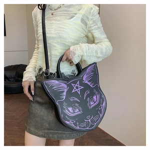 Close-up of gothic black cat head handbag with purple cat face print and star detail