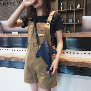 Funny navy blue shark shaped crossbody bag styled with a casual streetwear outfit
